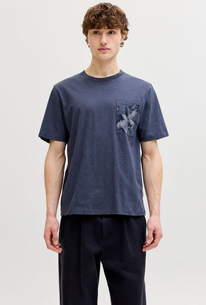 Front image of a model wearing Montauk aop pocket tee in navy, by brand Jack&jones