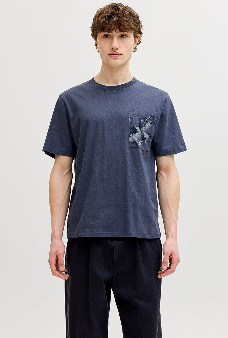 Front image of a model wearing Montauk aop pocket tee in navy, by brand Jack&jones