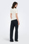 Back image of a model wearing the Catie s/s assymetric top in white, by brand Jacqueline de yong