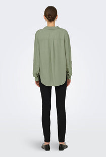Back image of a model wearing the Caya linen loose l/s shirt in sage, by brand Jacqueline de yong