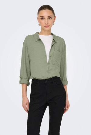 Front image of a model wearing the Caya linen loose l/s shirt in sage, by brand Jacqueline de yong