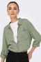 Front image of a model wearing the Caya linen loose l/s shirt in sage, by brand Jacqueline de yong