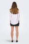 Back image of a model wearing the Caya linen loose l/s shirt in white, by brand Jacqueline de yong