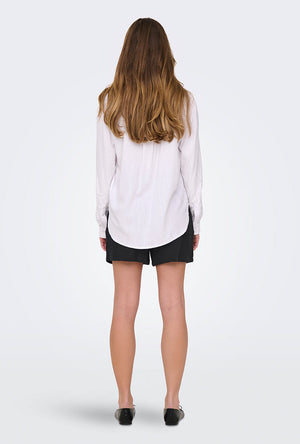 Back image of a model wearing the Caya linen loose l/s shirt in white, by brand Jacqueline de yong