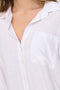 Front detailed image of a model wearing the Caya linen loose l/s shirt in white, by brand Jacqueline de yong