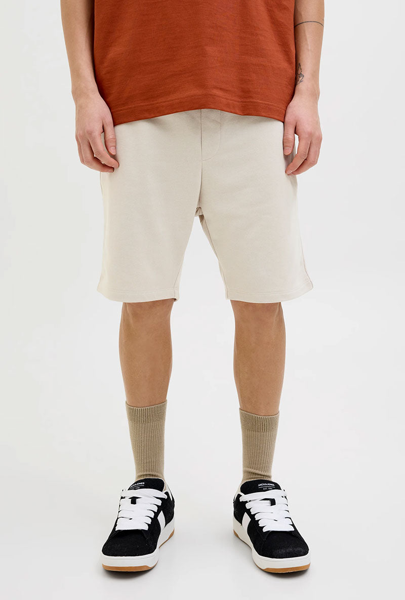 Front image of a model wearing Gordon bradley sweat shorts in stone, by brand Jack&jones