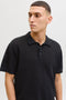 Front image of a model wearing the Jess knit polo in black, by brand Jack&jones