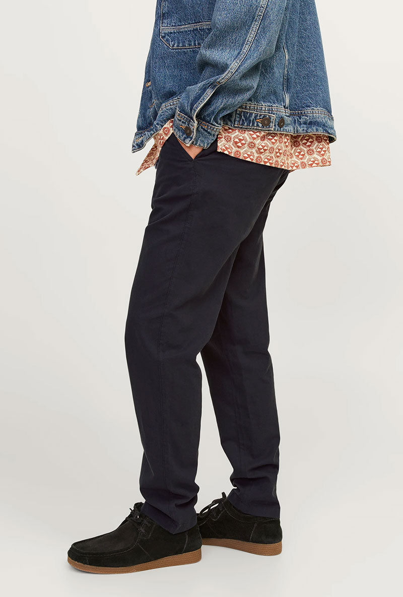 Side view image of a model wearing Jack and jones tace linen blend trousers in black, by brand Jack&jones