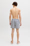 Back image of a model wearing the Maui ocean seersucker swimshorts in navy, by brand Jack&jones