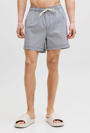Front image of a model wearing Maui ocean seersucker swimshorts in navy, by brand Jack&jones