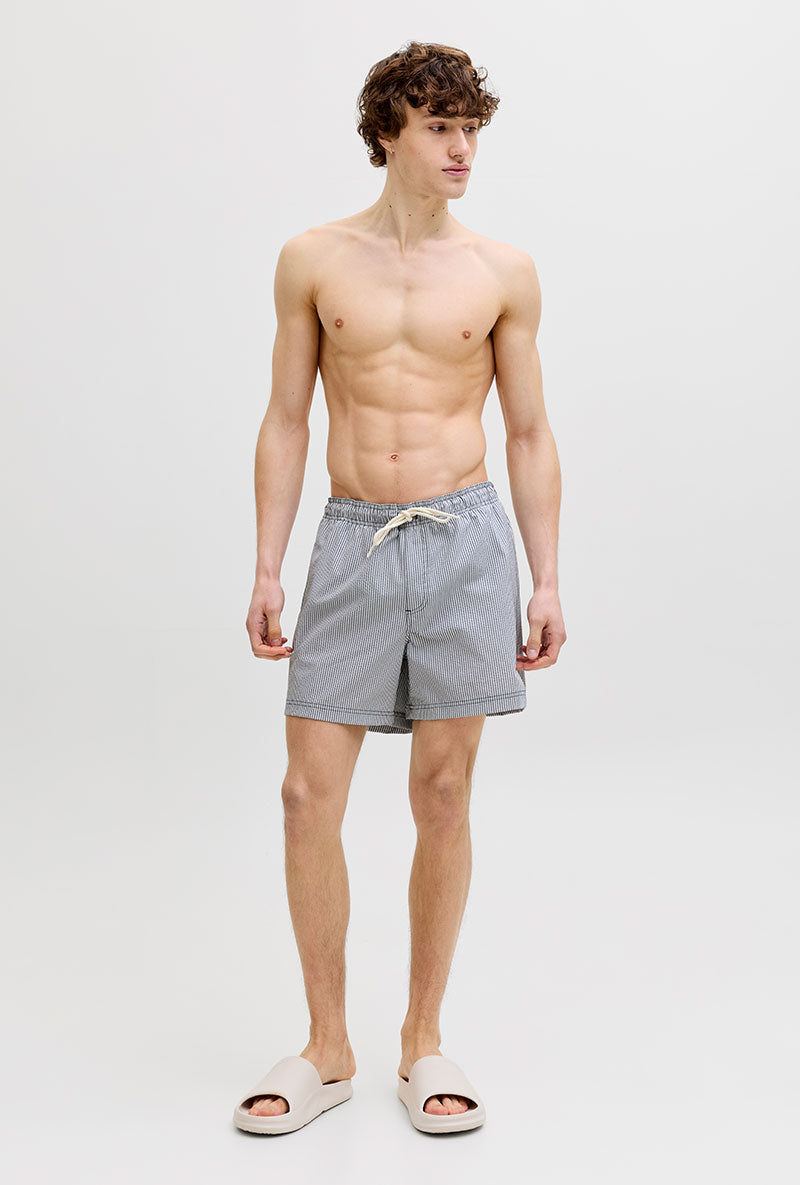 Front image of a model wearing Maui ocean seersucker swimshorts in navy, by brand Jack&jones