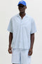 Front image of a model wearing Milo seersucker resort shirt in light blue, by brand Jack&jones