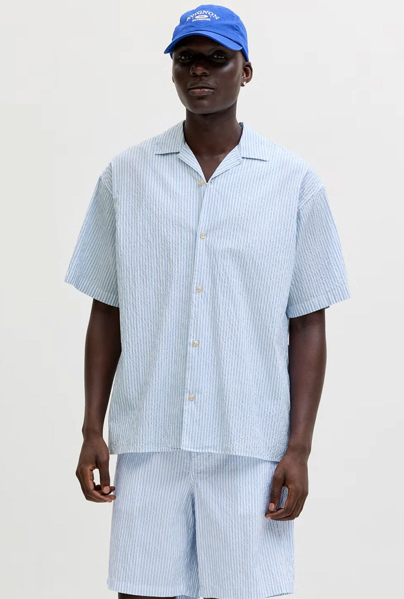 Front image of a model wearing Milo seersucker resort shirt in light blue, by brand Jack&jones