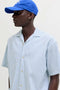 Front image of a model wearing the Milo seersucker resort shirt in light blue, by brand Jack&jones