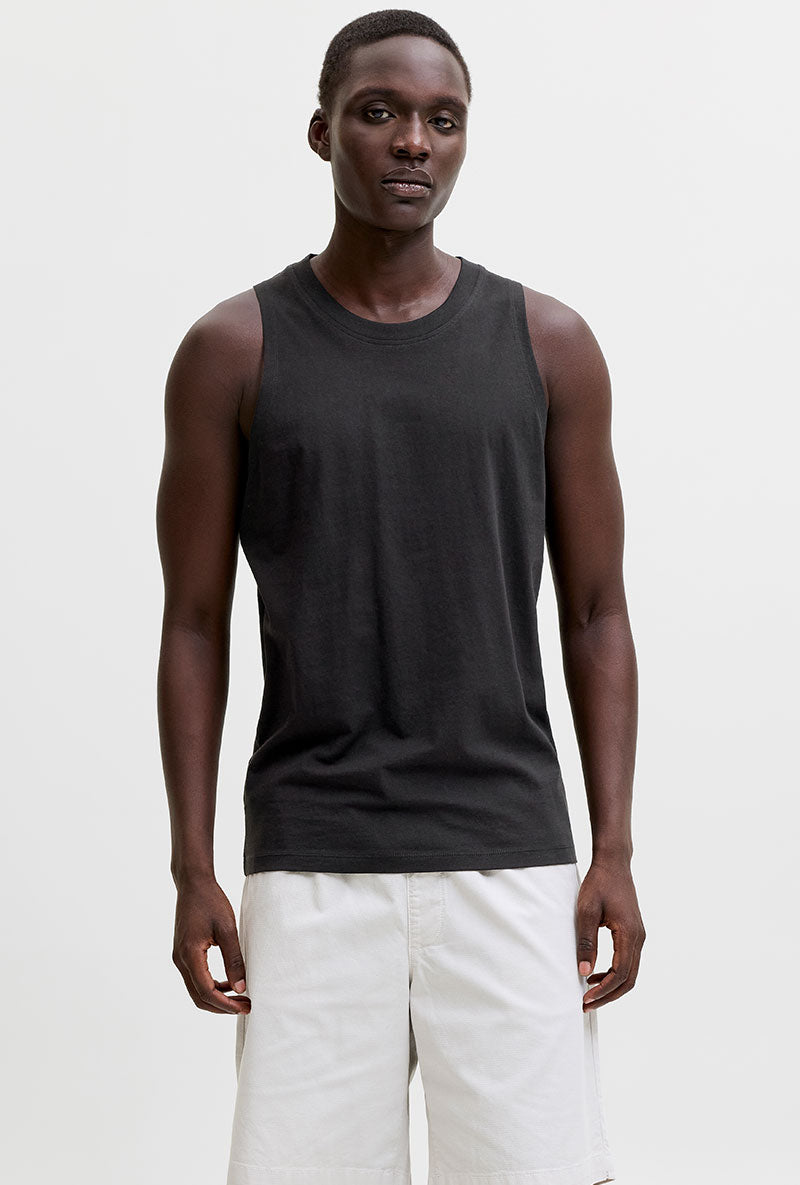Front image of a model wearing Sunset back print sleeveless tshirt in black, by brand Jack&jones