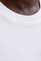 Front neck image of a model wearing the Sunset back print sleeveless tshirt in white, by brand Jack&jones