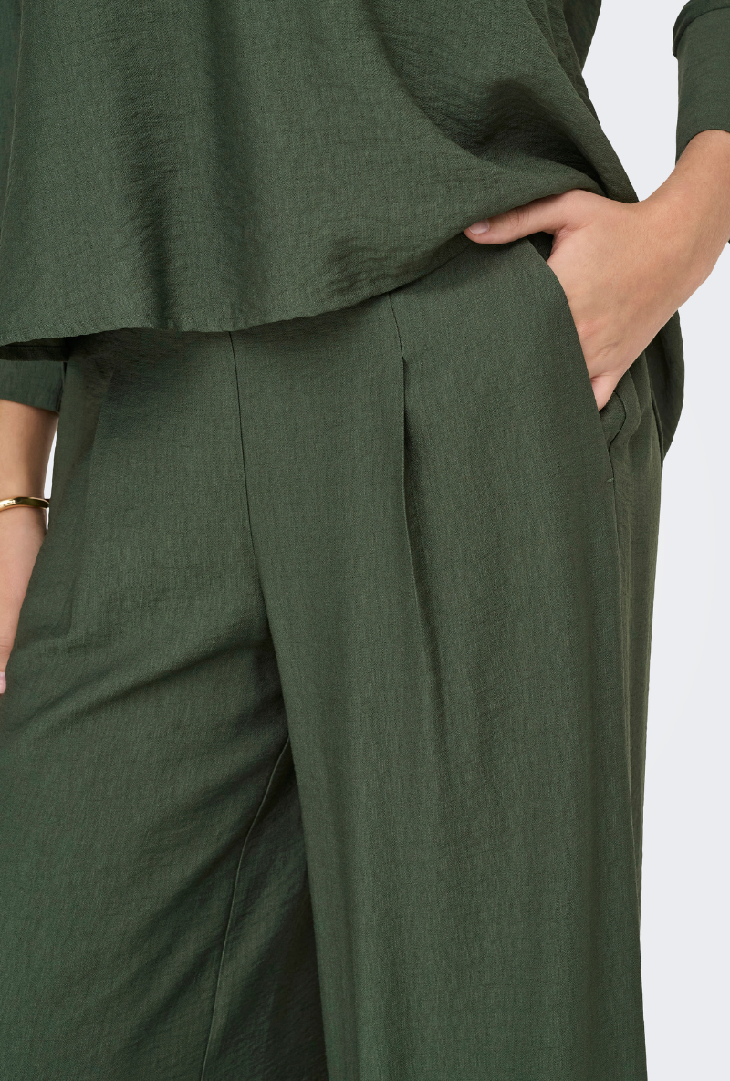 Detail image of a model wearing Jdy pepper palazzo pants in olive, by brand Jacqueline de yong
