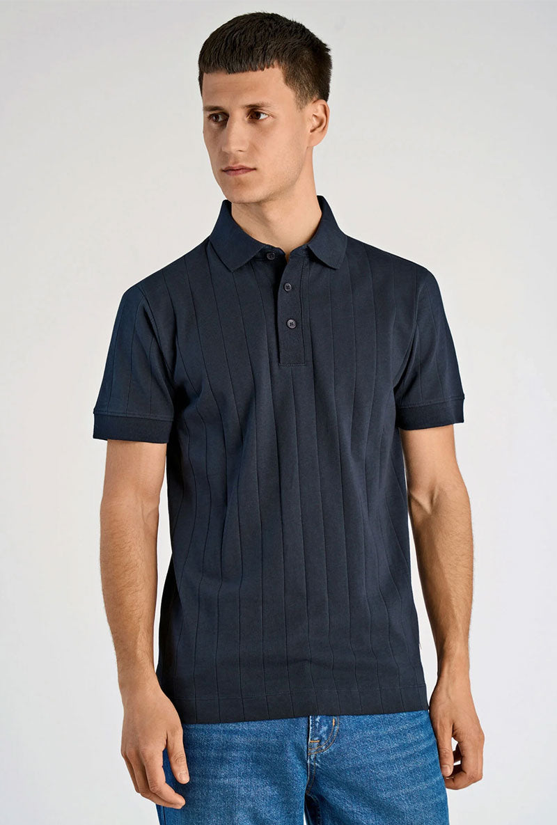 Front image of a model wearing Needle drop s/s polo in navy, by brand Lindbergh