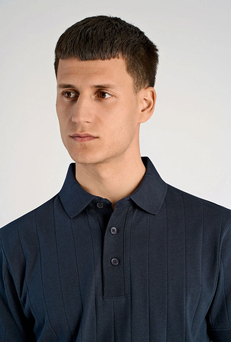 Front image of a model wearing Needle drop s/s polo in navy, by brand Lindbergh