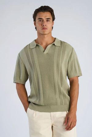 Front image of a model wearing the Knitted s/s polo in light green, by brand Lindbergh