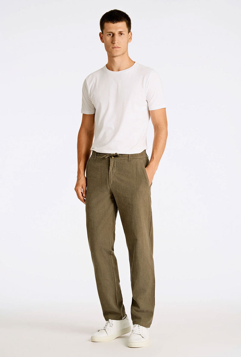 Front image of a model wearing Relaxed fit linen trousers in khaki, by brand Lindbergh