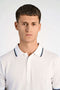 Front image of a model wearing the S/s contrast polo in white, by brand Lindbergh