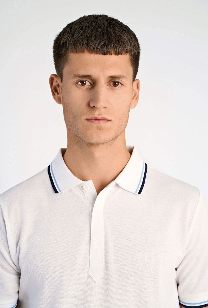 Front image of a model wearing S/s contrast polo in white, by brand Lindbergh