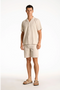 Front image of a model wearing the Seersucker s/s shirt in beige, by brand Lindbergh