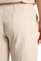 Back detail image of a model wearing the Seersucker shorts in beige, by brand Lindbergh