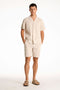 Front image of a model wearing the Seersucker shorts in beige, by brand Lindbergh