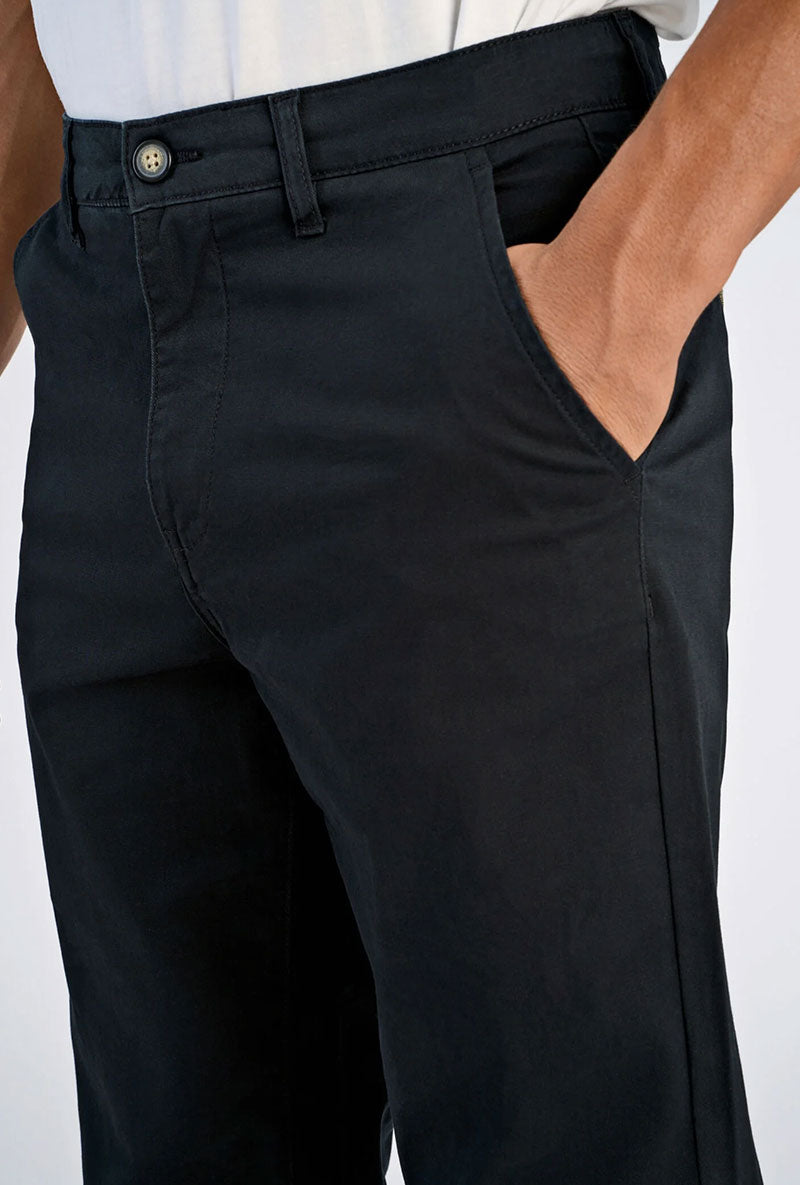 Front image of a model wearing Superflex relaxed fit chino pants in black, by brand Lindbergh