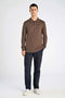 Front image of a model wearing the Ecovero ls polo in brown, by brand Lindbergh