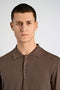 Front image of a model wearing the Ecovero ls polo in brown, by brand Lindbergh