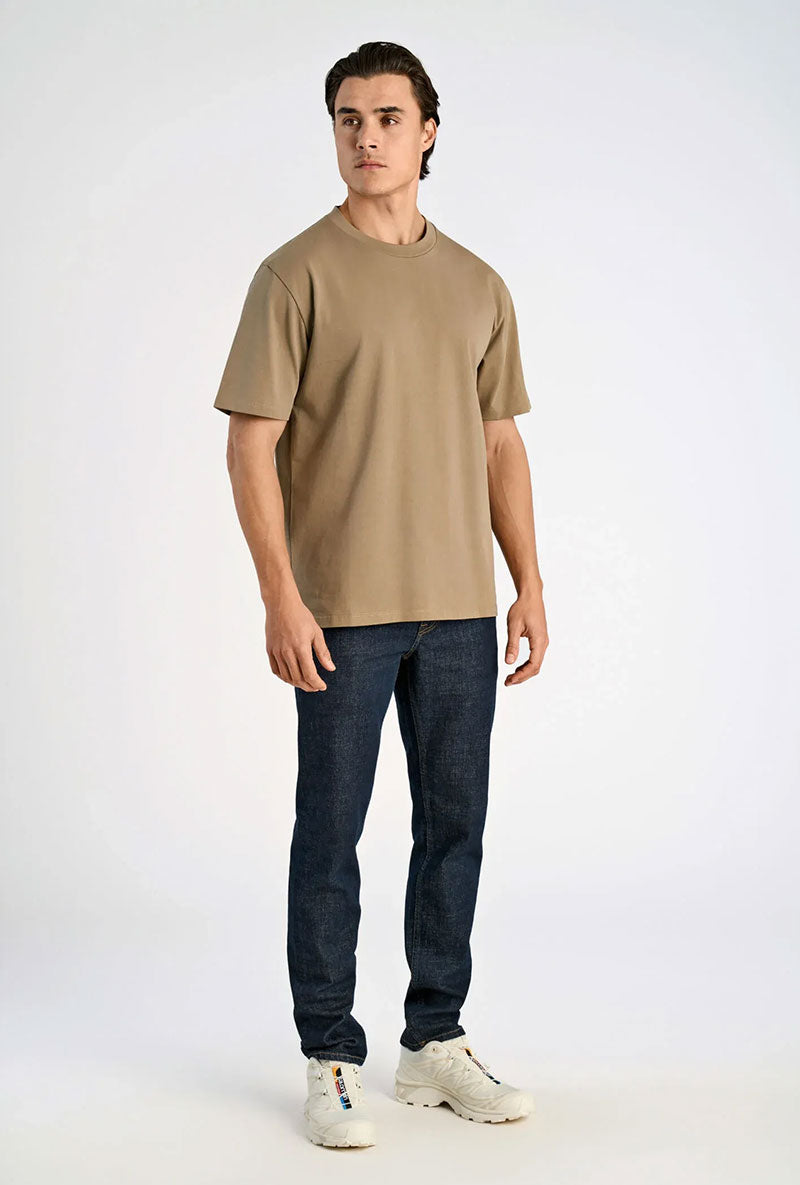 Front image of a model wearing Oneck oversize tshirt in stone, by brand Lindbergh