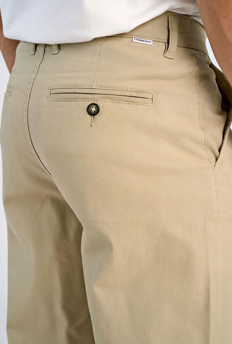 Back image of a model wearing Superflex chino pants in sand, by brand Lindbergh
