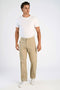 Front image of a model wearing the Superflex chino pants in sand, by brand Lindbergh