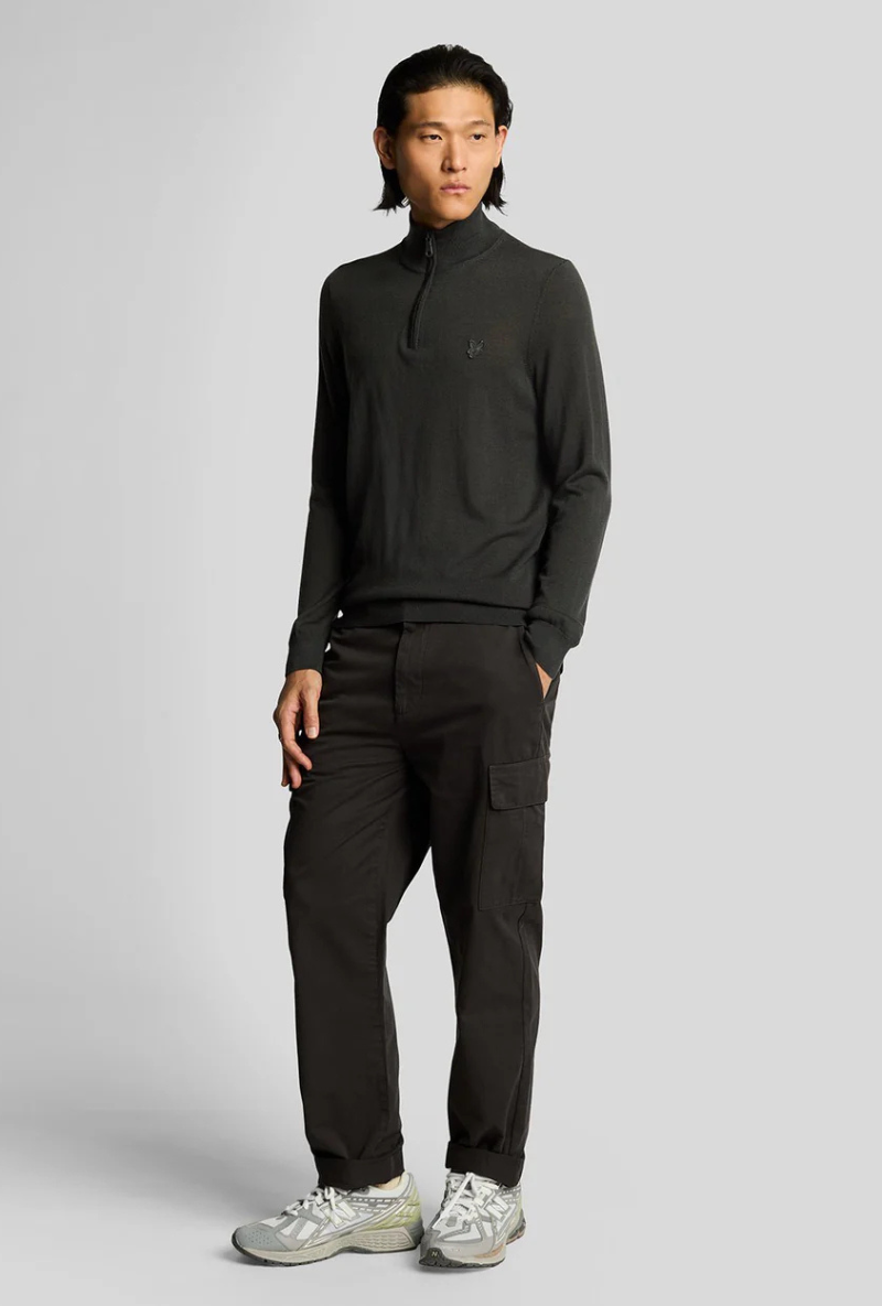 Front image of a model wearing Lyle and scott cargo pocket trousers in black, by brand Lyle and scott