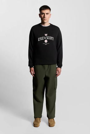 Front image of a model wearing Lyle and scott cheers to tradition sweatshirt in black, by brand Lyle and scott