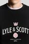 Front detail image of a model wearing the Lyle and scott cheers to tradition sweatshirt in black, by brand Lyle and scott