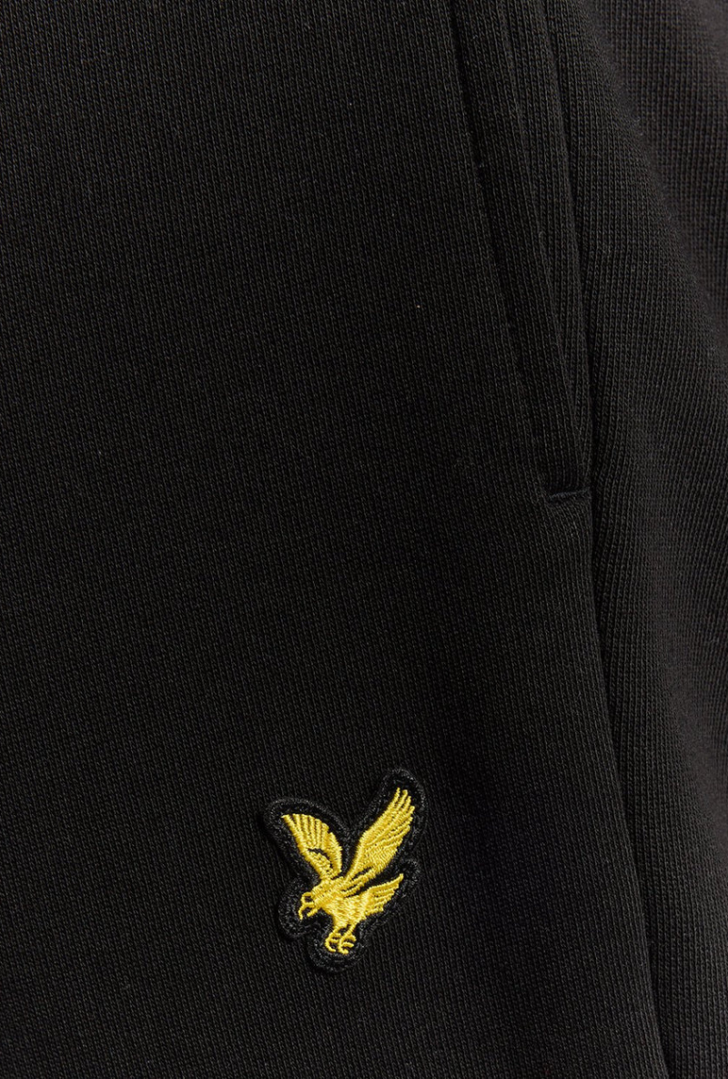 Front detail image of a model wearing Lyle and scott straight leg jogger in black, by brand Lyle and scott
