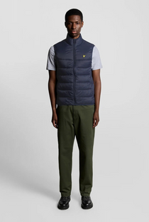 Front image of a model wearing the Lyle and scott wadded gilet in navy, by brand Lyle and scott