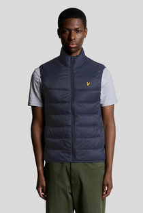 Front image of a model wearing the Lyle and scott wadded gilet in navy, by brand Lyle and scott