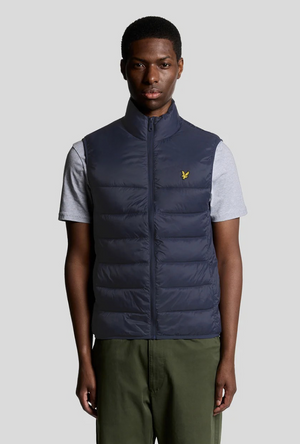 Front image of a model wearing the Lyle and scott wadded gilet in navy, by brand Lyle and scott