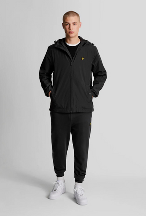Front image of a model wearing Lyle and scott zip through hooded jacket in black, by brand Lyle and scott
