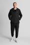 Front image of a model wearing Lyle and scott zip through hooded jacket in black, by brand Lyle and scott
