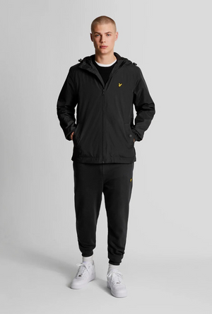 Front image of a model wearing the Lyle and scott zip through hooded jacket in black, by brand Lyle and scott