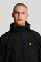 Front image of a model wearing the Lyle and scott zip through hooded jacket in black, by brand Lyle and scott