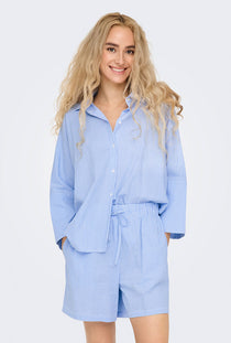 Front image of a model wearing the Augusta s/s shirt in light blue, by brand Only