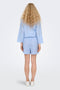 Back image of a model wearing the Augusta shorts in light blue, by brand Only