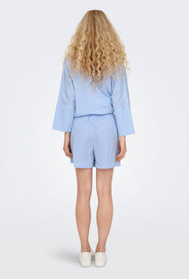Back image of a model wearing the Augusta shorts in light blue, by brand Only